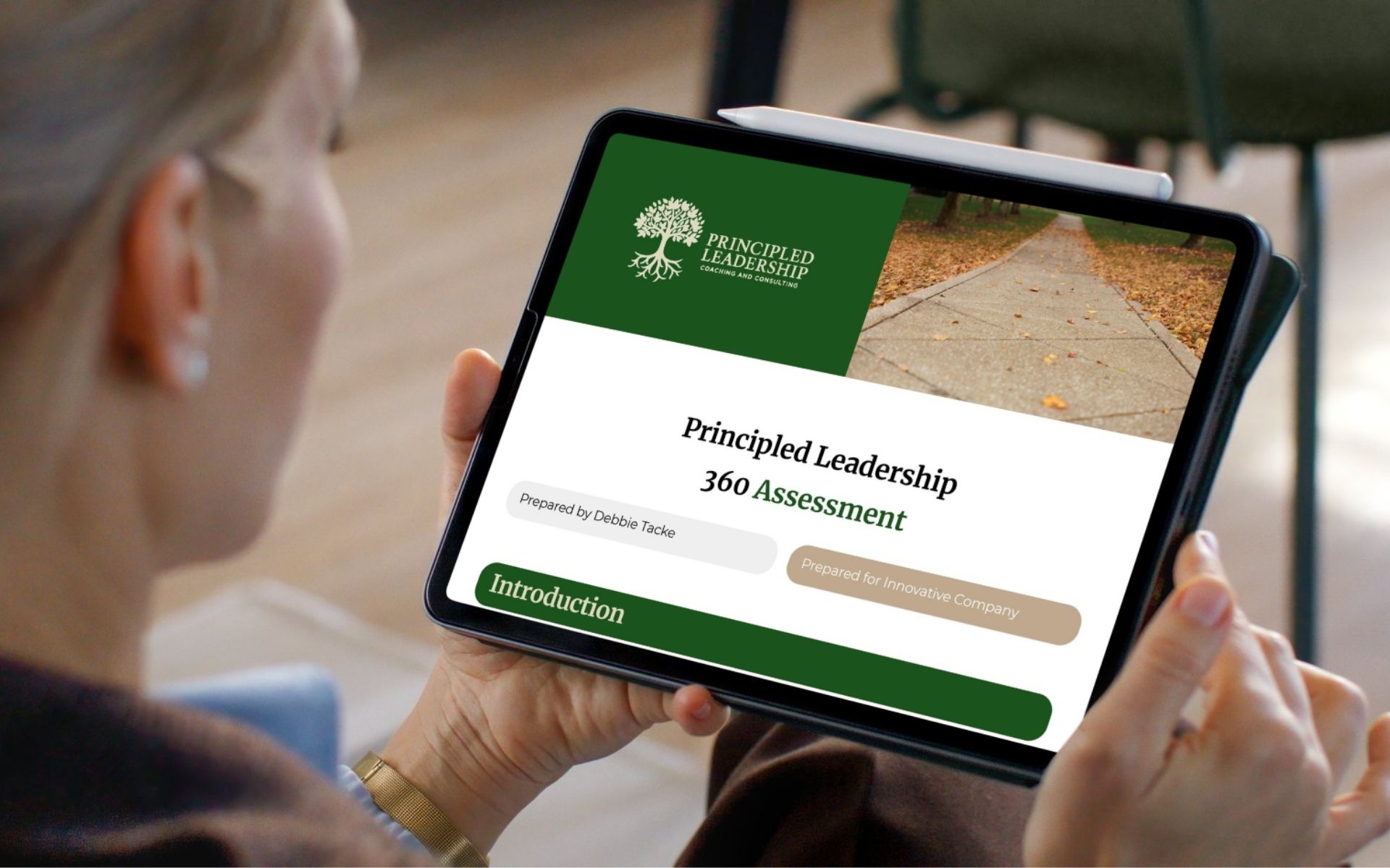 Image of woman looking down on her iPad of a Principled Leadership 360 Assessment document